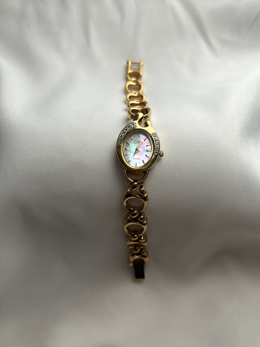 Gold watch with mother of pearl face