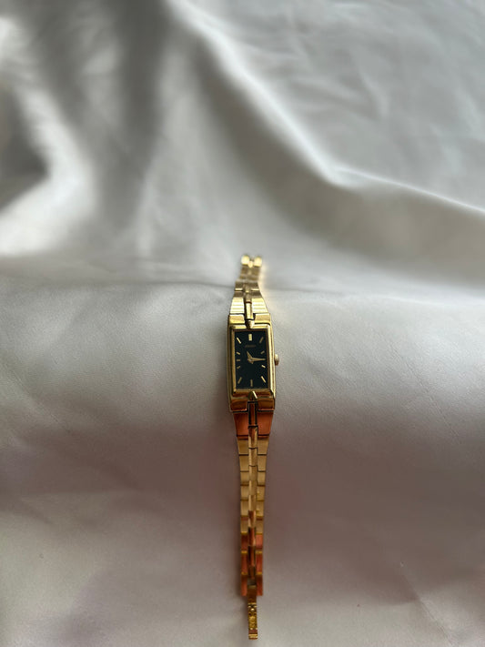 Dainty gold seiko watch with black face